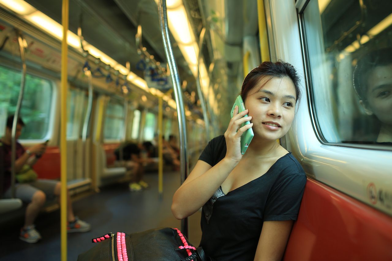 Person on their phone in a train