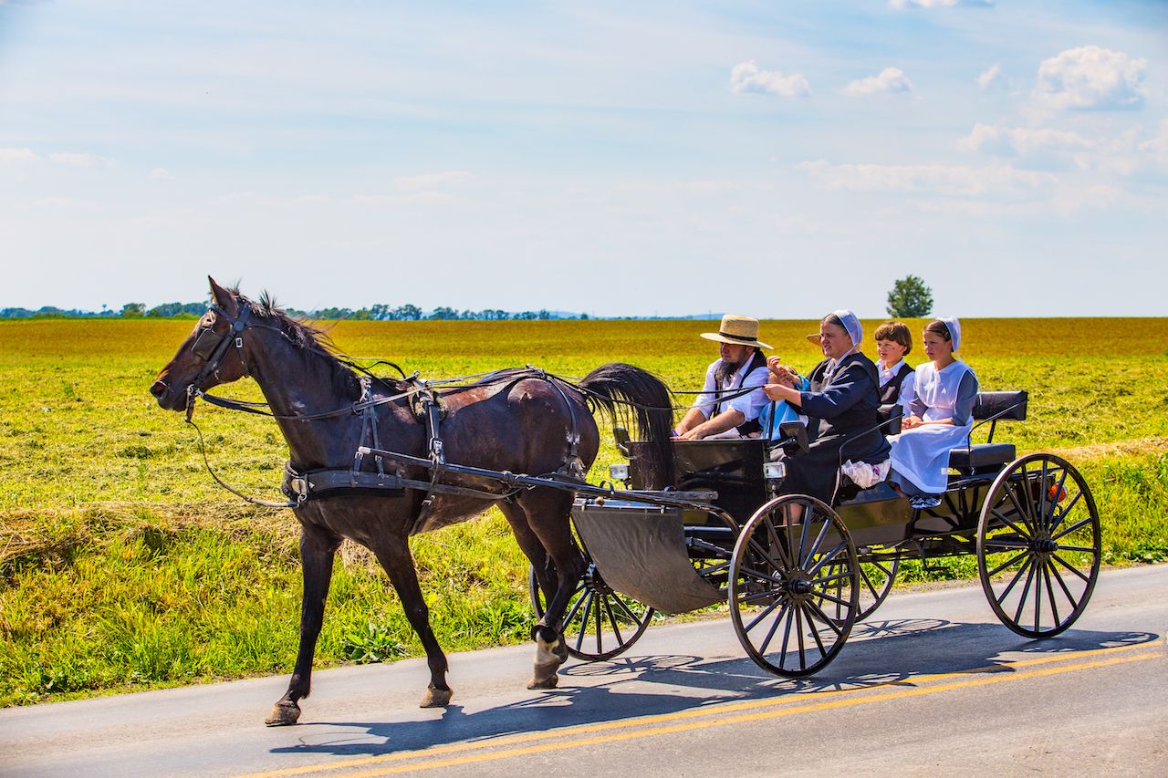 Amish family ride in an open wagon in Lancaster County, Pennsylvania