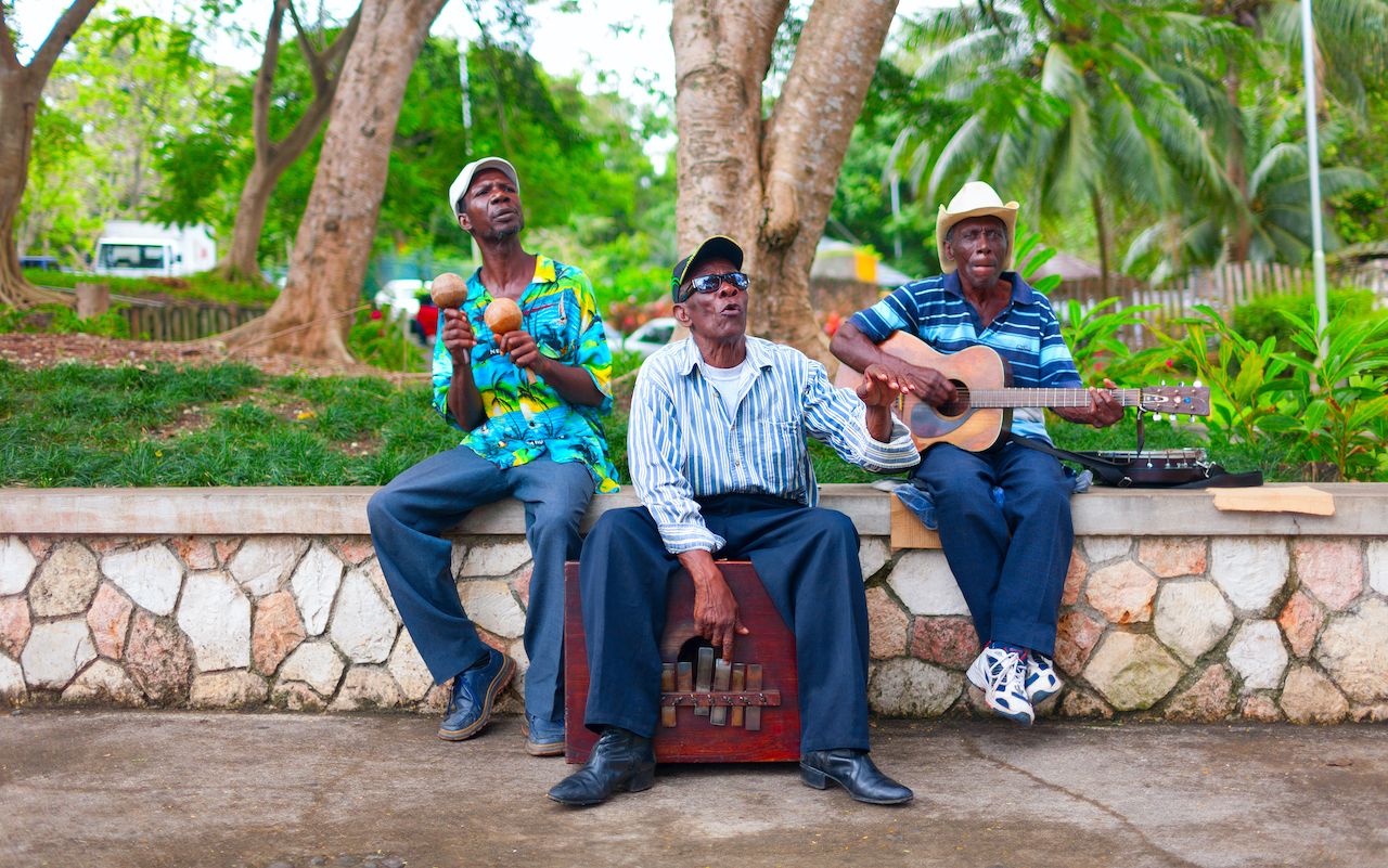 A group of local musicians are playing traditional music in Jamaica